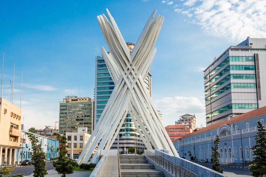 A modern bridge with a unique X-shaped structure in an urban setting. 3