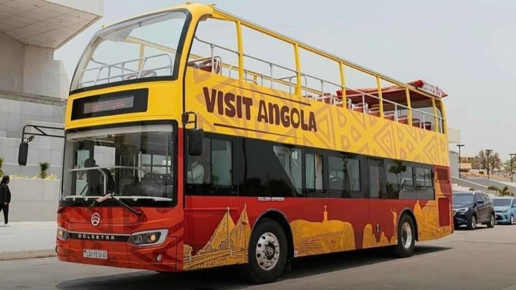 A double-decker bus with 'VISIT ANGOLA' written on the side. 1