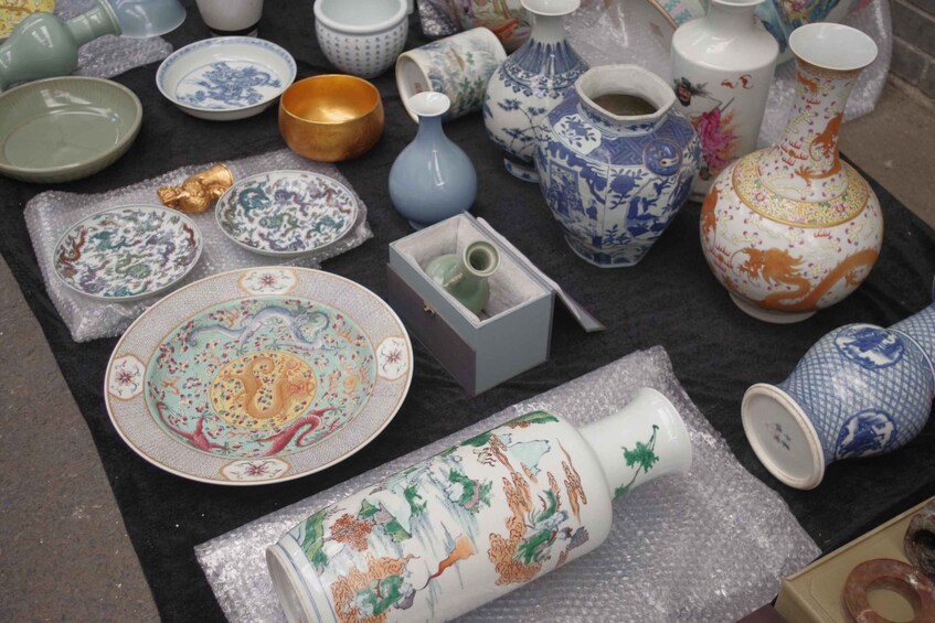 A variety of ceramic dishes and vases on a table. 1
