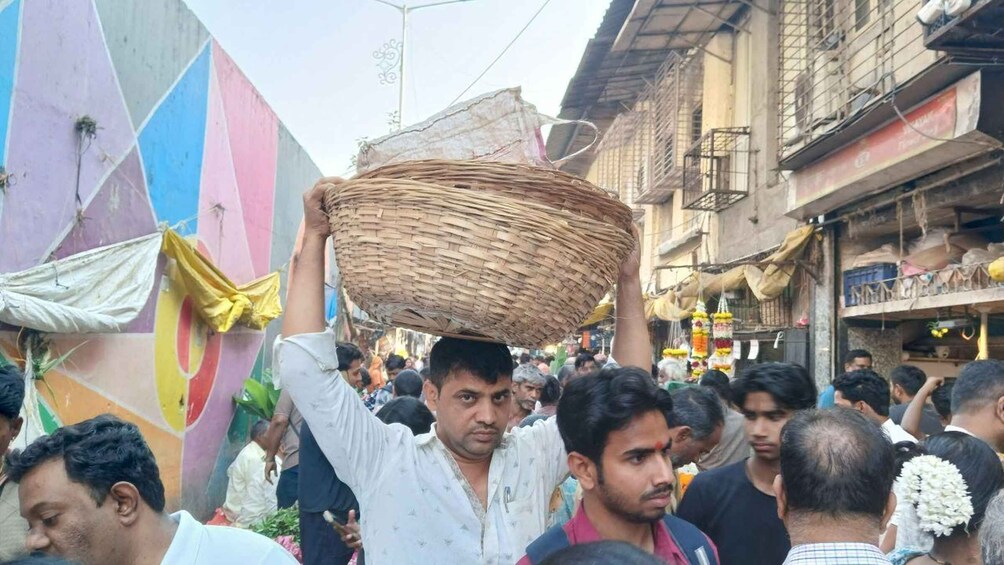 A crowded street with people carrying baskets. 4