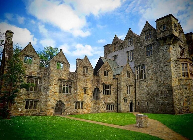 A historic stone building with multiple towers and arched windows. 2