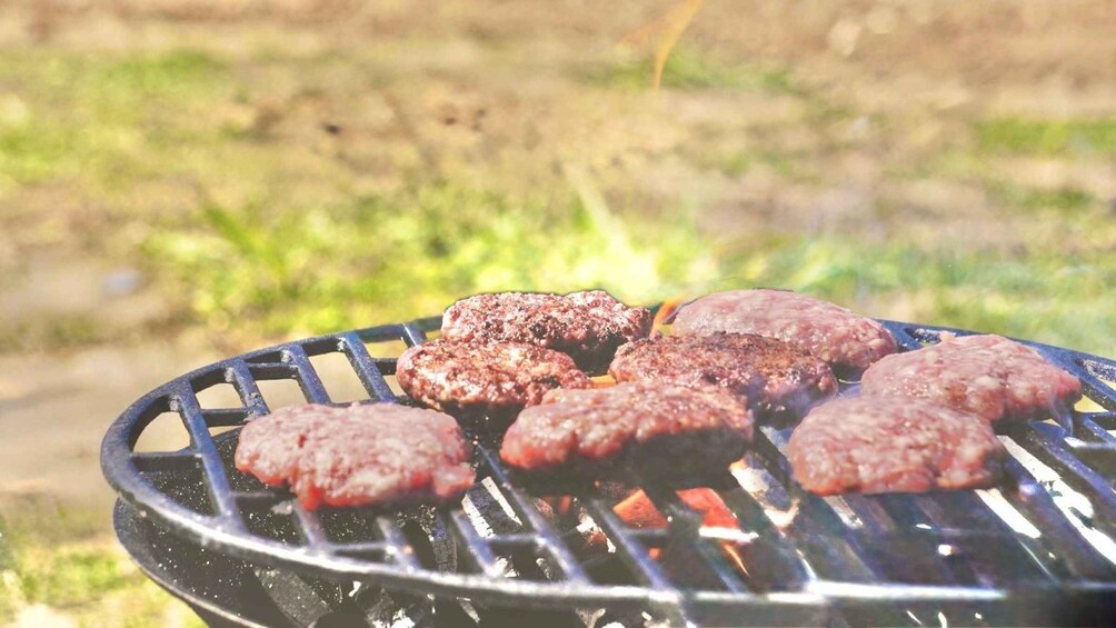 Hamburgers grilling on an outdoor grill. 3