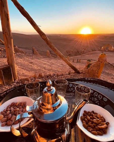 A table with coffee beans, glasses, and a traditional tea pot at sunset. 4