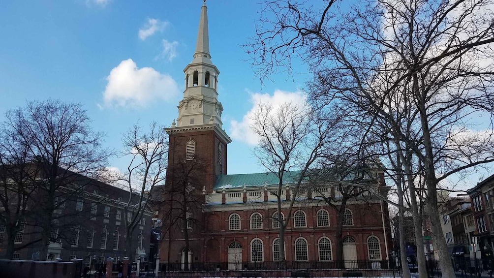 A historic building with a tall steeple and a clock tower. 4
