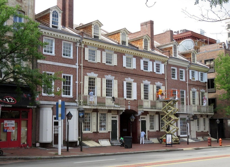A historic building with a United States Post Office sign, a sports lounge, and a National lease office. 2