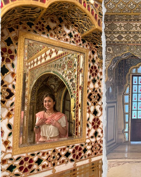 A person standing in front of an ornate mirror with intricate designs and a patterned wall. 5