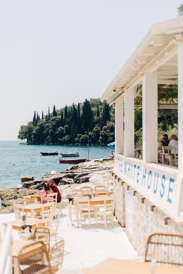 A coastal restaurant named "The White House" with outdoor seating overlooking the sea. 4