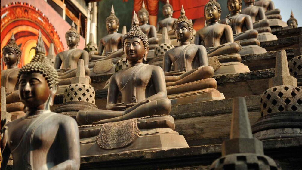 A row of seated Buddha statues in a temple. 1