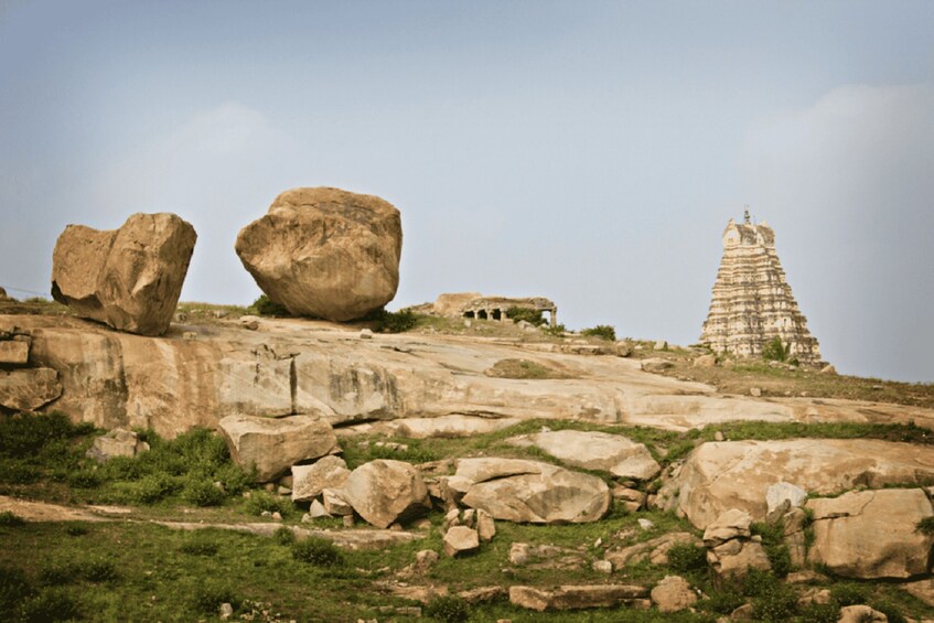 A rocky landscape with large boulders and a temple-like structure. 2