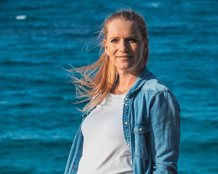 A person standing by a body of water. 2