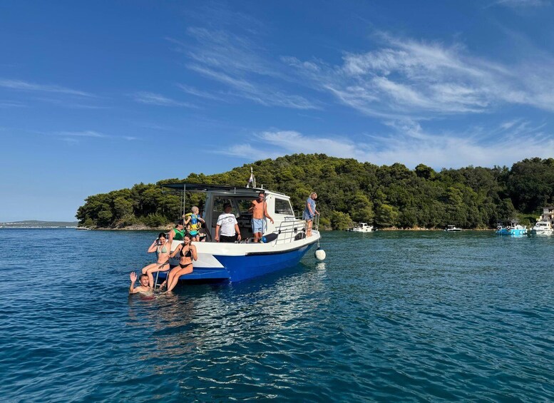 A boat with people on a calm lake, surrounded by lush greenery and a clear sky. 2