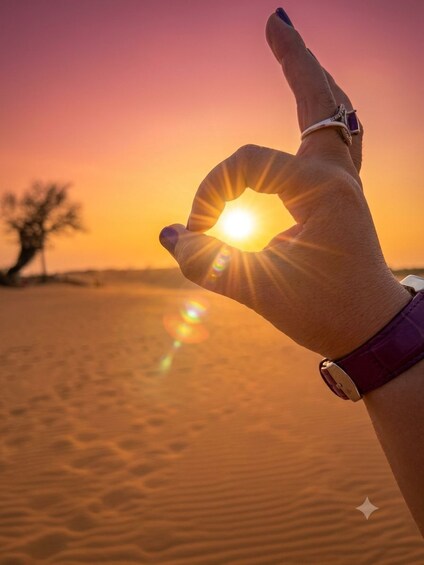 A hand making an OK gesture with the sun shining in the background. 5