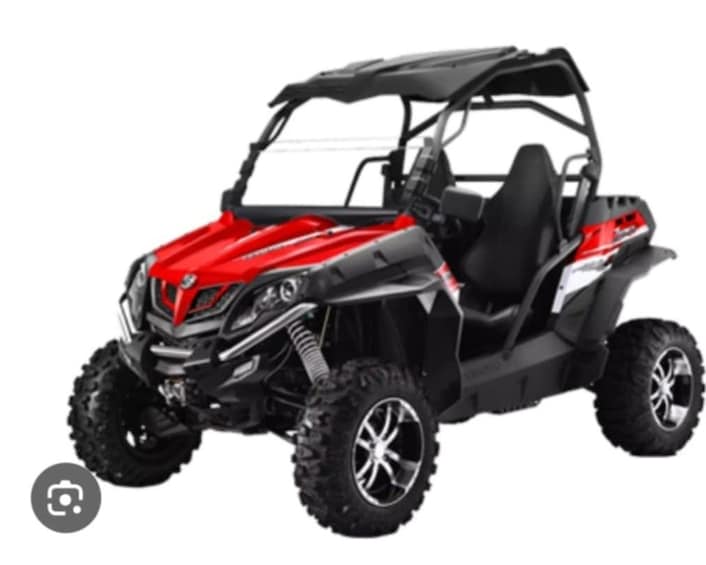A red and black off-road vehicle with a windshield and four wheels. 5