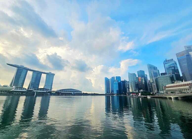 A city skyline with modern skyscrapers and the Marina Bay Sands hotel reflected in the water. 2