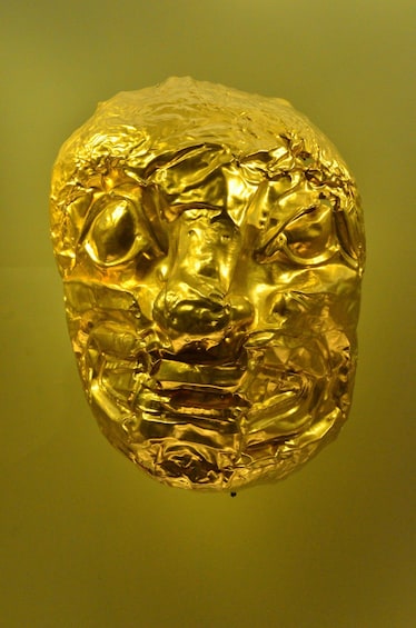 A golden sculpture with a textured surface. 4