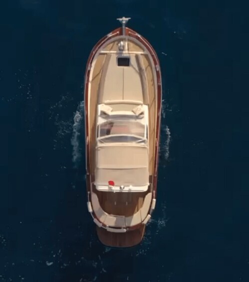 A boat with a cabin and a red flag on the back. 1