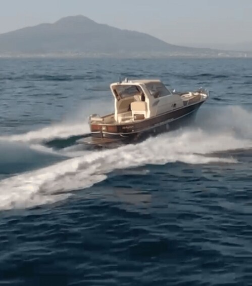 A speedboat moving through the water with waves created behind it. 2