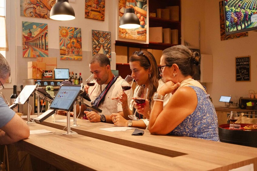 A wine tasting event with people sampling wine at a counter. 4