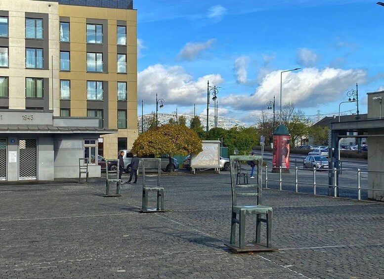 A paved square with benches, a building with the number 1943, and a red telephone booth. 1