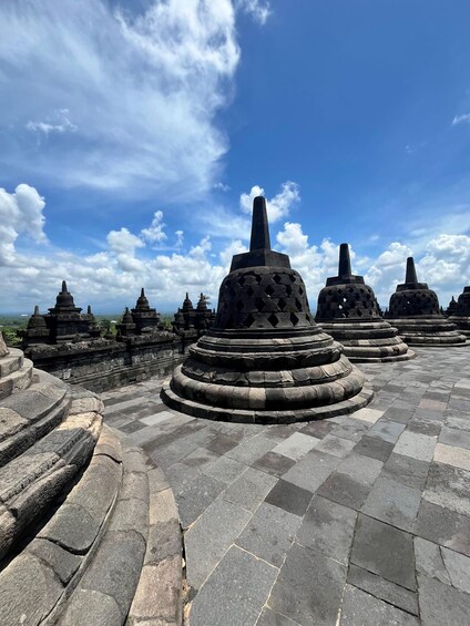 A temple complex with stone structures and a clear sky. 5