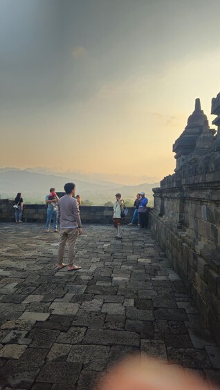 A stone pathway leading to a temple with a view of distant mountains. 4