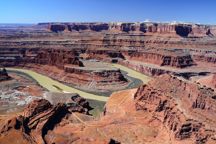A canyon with layered rock formations and a winding river. 5