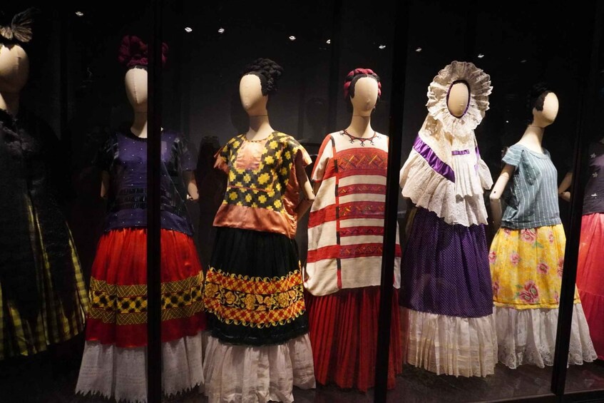 Mannequins dressed in colorful traditional dresses. 3