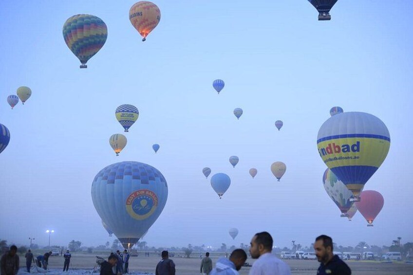 A hot air balloon festival with multiple balloons in the sky. 3