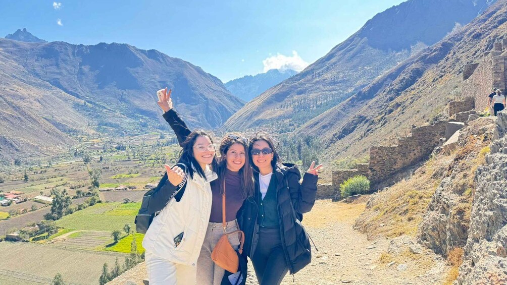 Three people taking a selfie with a mountainous landscape in the background. 5