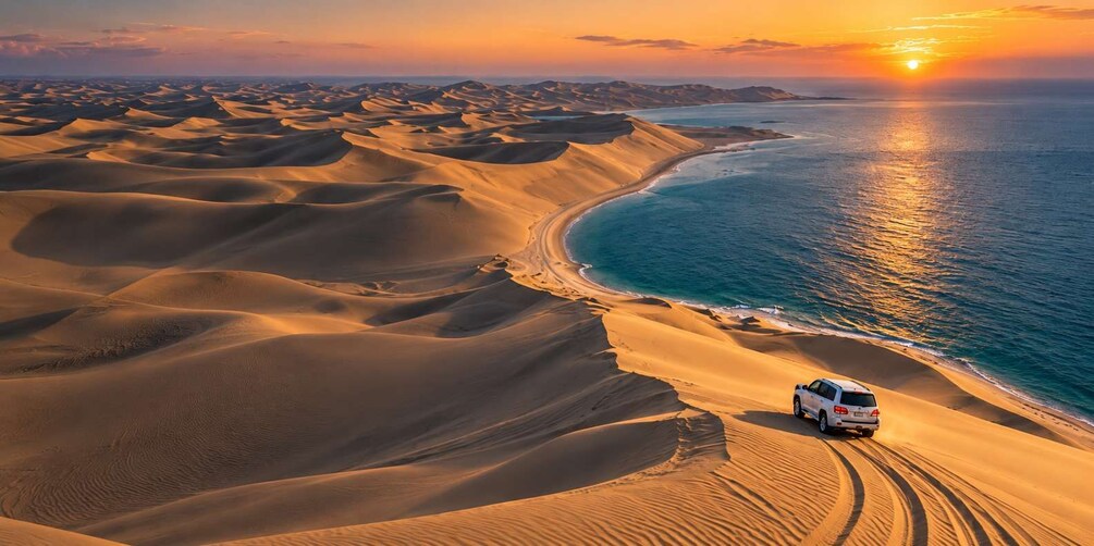 A desert landscape with sand dunes and a white vehicle on a trail. 2