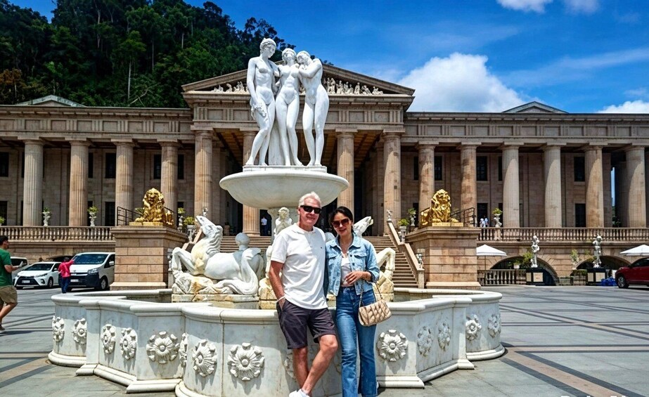 A classical fountain with sculptures, a large building with columns, and a clear blue sky. 3