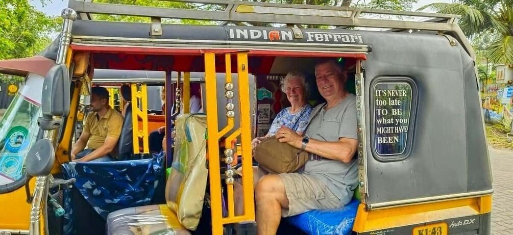 An Indian Ferrari auto-rickshaw with passengers and a motivational quote on the side. 4