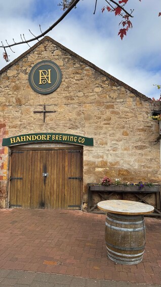 A traditional stone building with a wooden door and a sign reading 'HAHNDORF BREWING CO.' 4