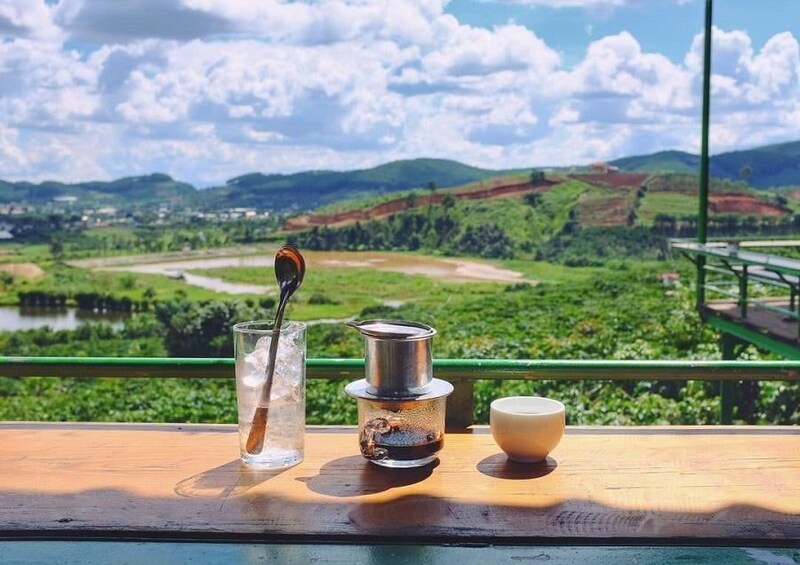 A wooden table with a glass of water, a teapot, and a cup. 2