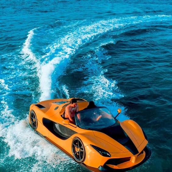A bright orange sports car driving on water. 5