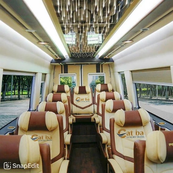 A luxury train interior with beige and brown leather seats, a central aisle, and a modern ceiling design. 3