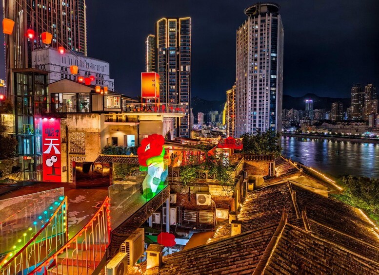 A nighttime cityscape with illuminated buildings, a river, and traditional architecture. 2