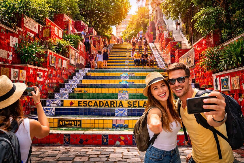 A colorful staircase with people taking photos. 1