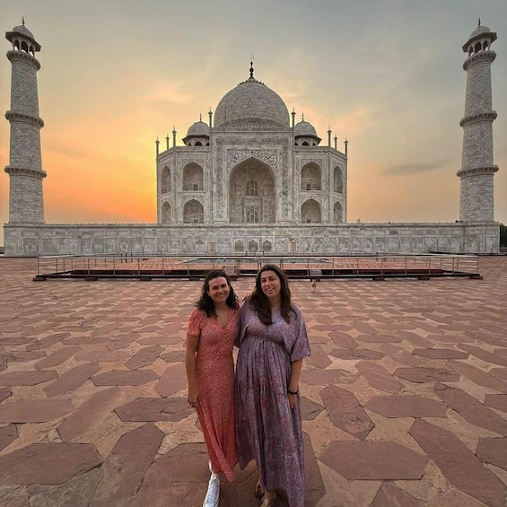 The Taj Mahal with two people standing in front. 5