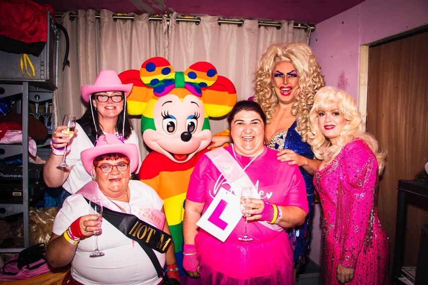 A group of people at a party with a Minnie Mouse mascot. 5
