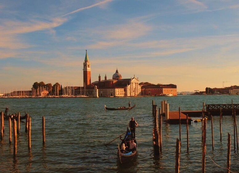 A gondola on Venice's Grand Canal, with historic buildings and the Doge's Palace in the background. 2