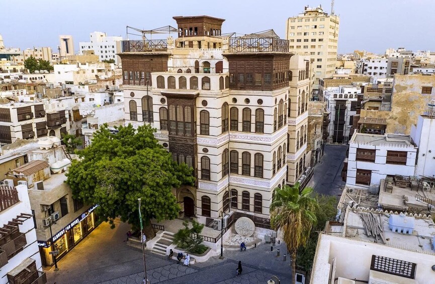 A historic building with intricate architecture, surrounded by a densely packed urban area with other buildings and a street. 4