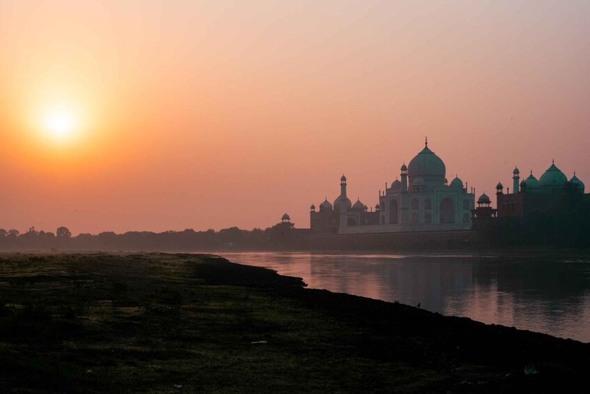 The Taj Mahal at sunrise with the sun low on the horizon. 2