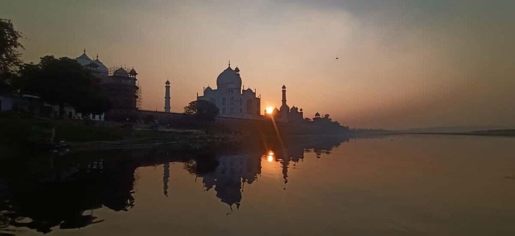 The Taj Mahal at sunset with its reflection in the water. 3