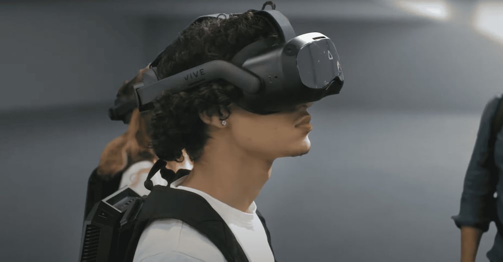 A person wearing a VR headset with a 'VIVE' logo. 2