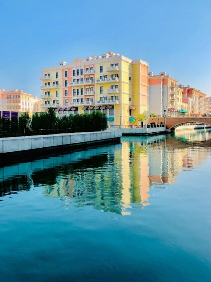 A canal with a reflection of colorful buildings. 2