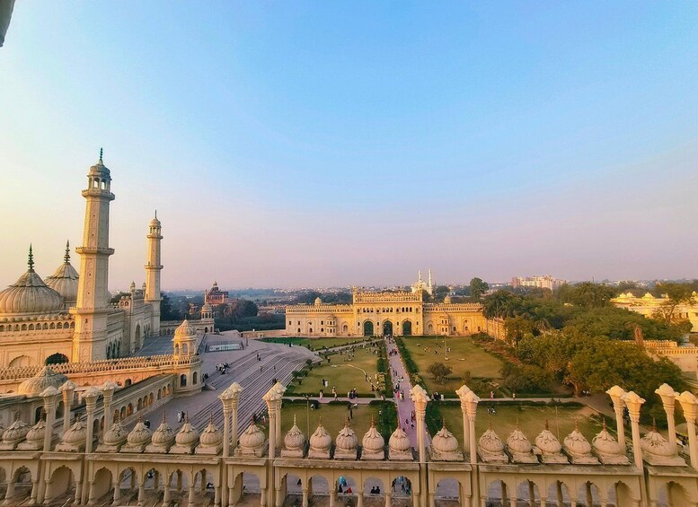 A large historical building with domes and minarets, surrounded by a well-maintained garden and pathways. 5