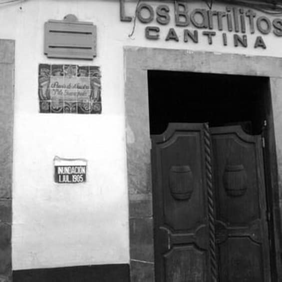 A building with a sign that reads "Los Barrios Cantina". 5