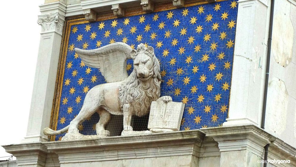 A stone lion statue with wings and a book, set against a blue background with golden stars. 5