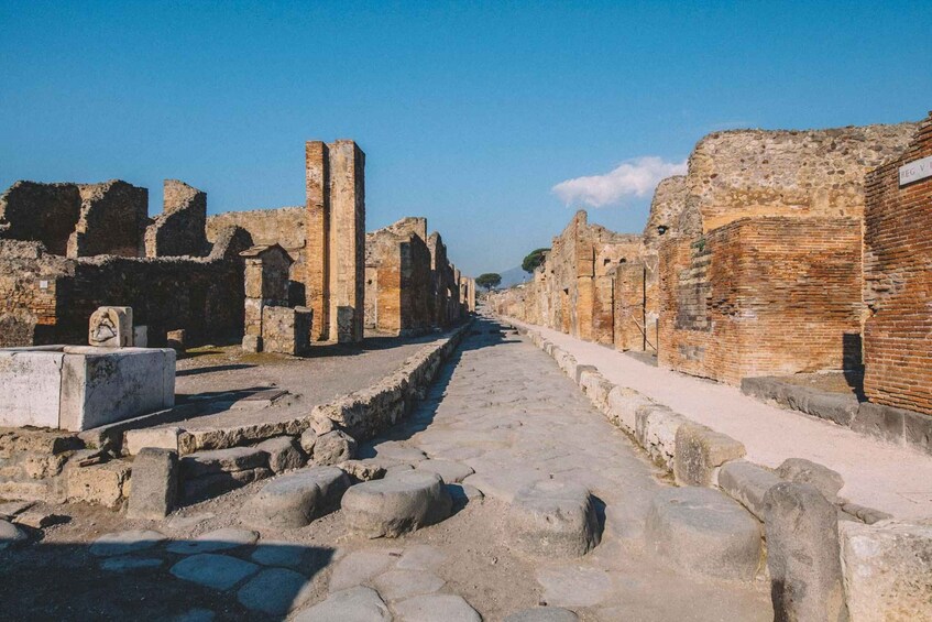 Ancient ruins with stone pathways and brick walls. 5